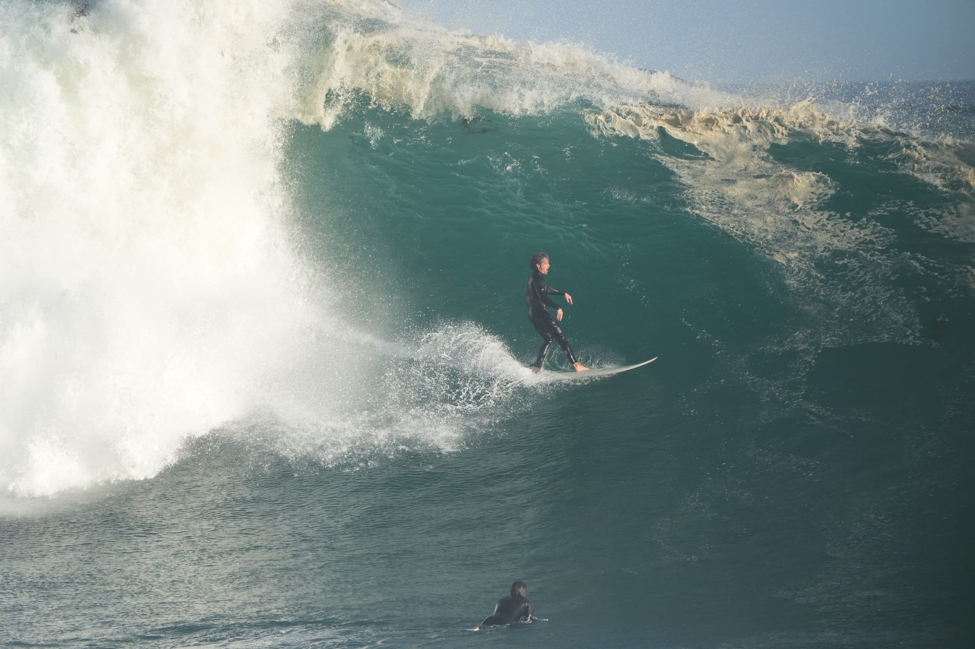 Surfer dropping into a heavy barrel