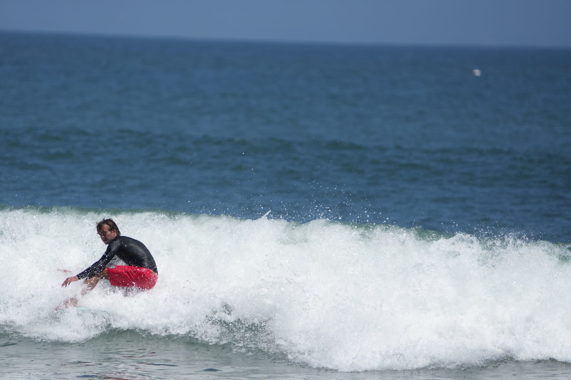 Surfer carving a shoulder-high wave