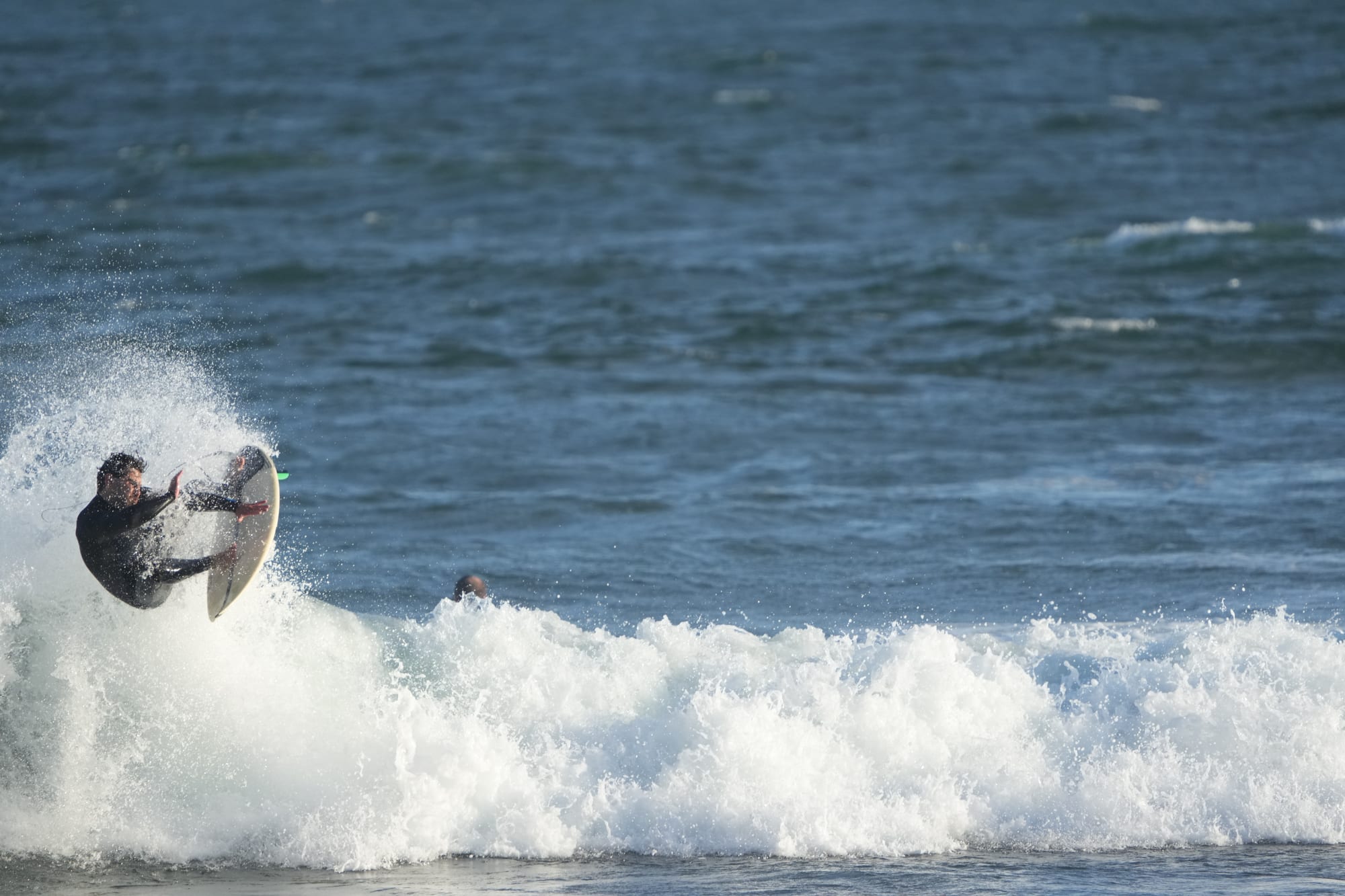Surfer launching off the lip