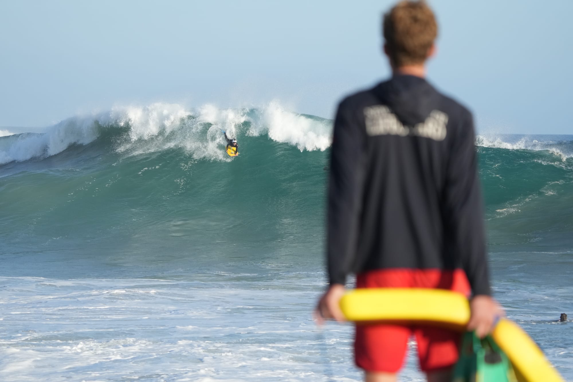 Lifeguard watching a set from the sand