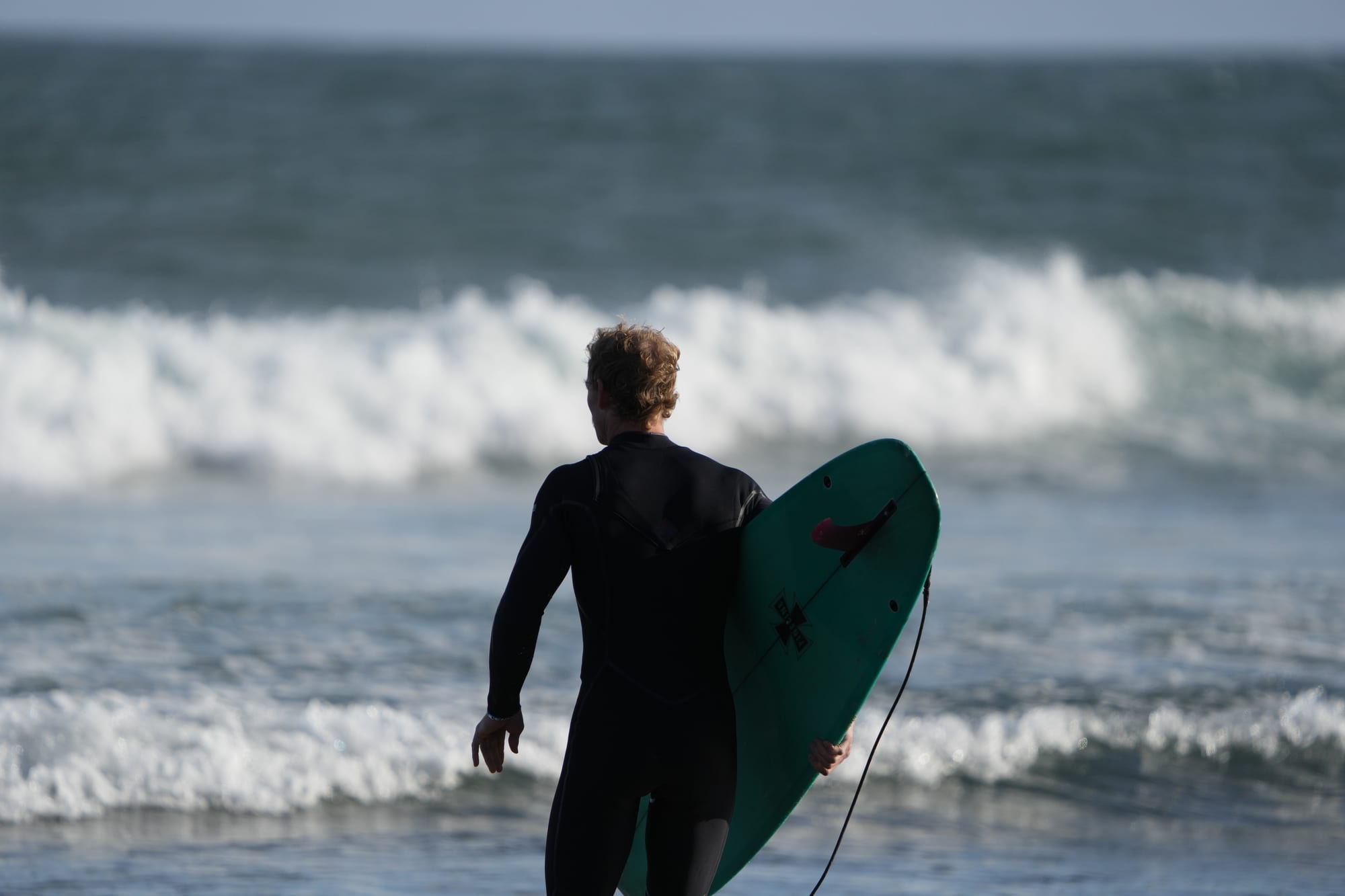 Surfer walking out with his board