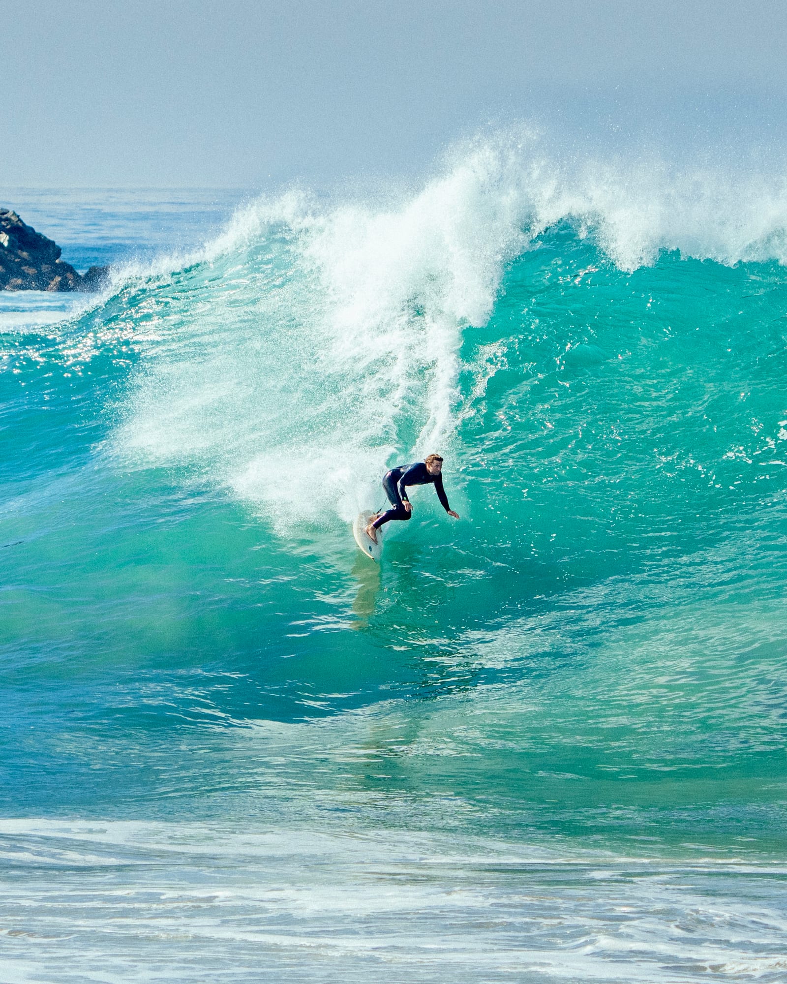 Surfer dropping into a glassy wave