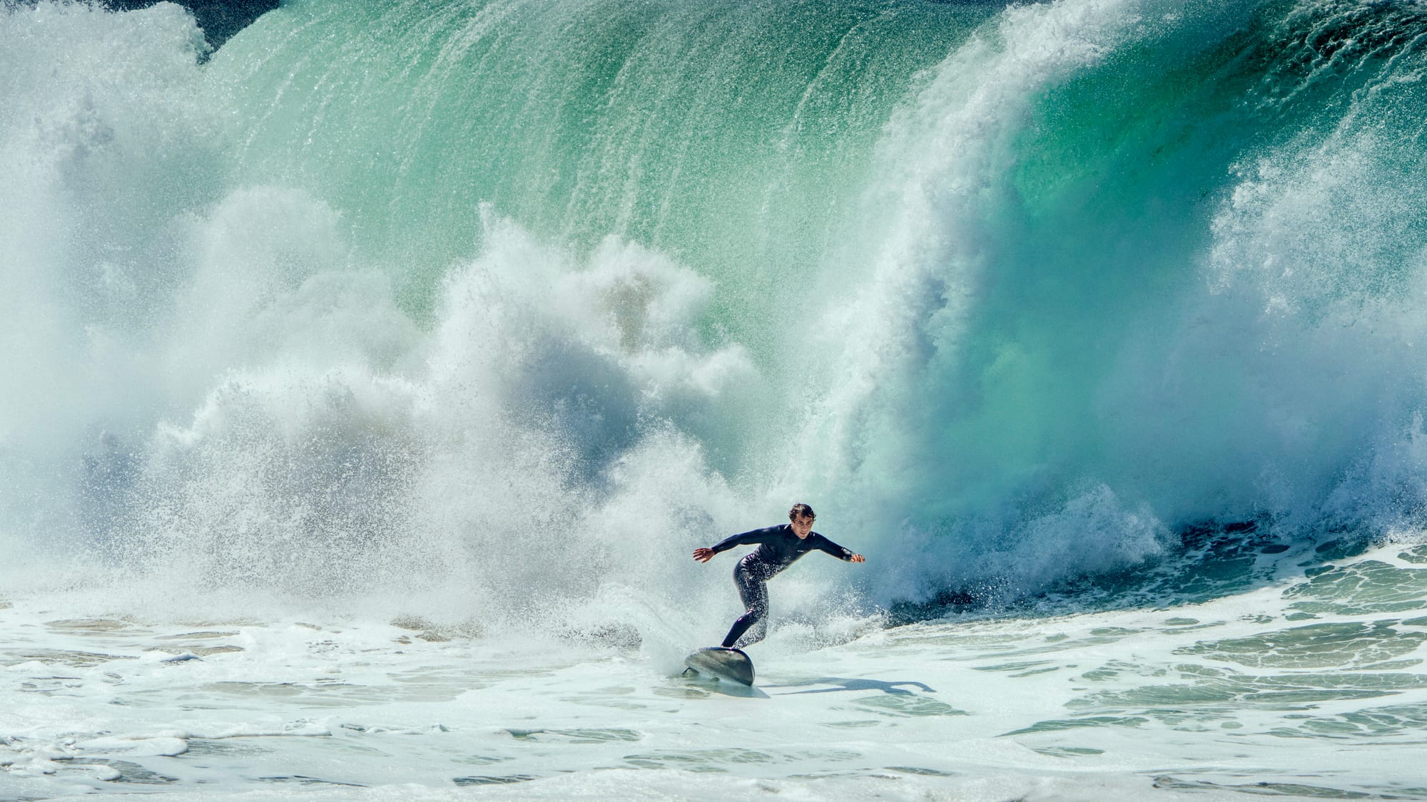 Surfer racing a heavy closeout